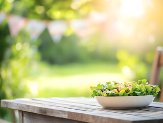 Fresh salad on rustic wooden table in sunny garden setting