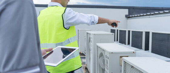 Engineers use blueprint check air condition systems on site. Contractor and inspector inspection...