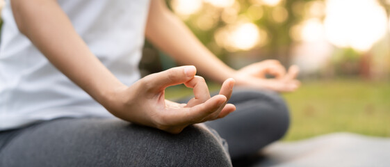 woman practicing meditate on the park. Asian woman doing exercises in morning. balance, recreation,...