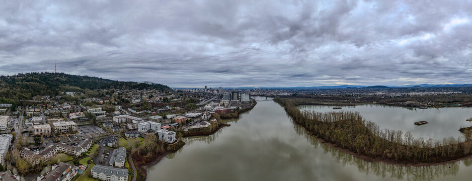 Panoramic aerial view captured by drone over the Willamette river leading into the city of Portland Oregon in the Pacific Northwest. 