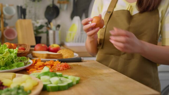 Close up of woman cooking healthy foods in kitchen in morning at home. 