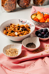 close-up of healthy breakfast with homemade granola and fruits mango, papaya and grapes