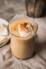 Coffee with ice cream and cinnamon in glass cup. Selective focus.
