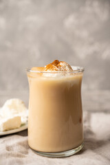 Coffee with ice cream and cinnamon in glass cup. Selective focus.
