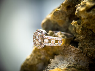“Close-Up of a Diamond Ring on Rustic Rocks”