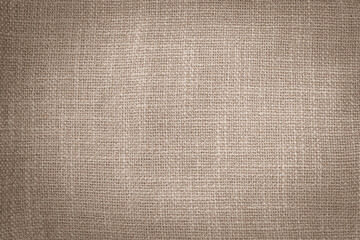 Hessian sackcloth woven jute burlap fabric cloth textile texture pattern background in sepia brown beige aged color