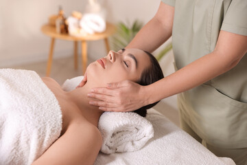 Young woman receiving massage in spa salon