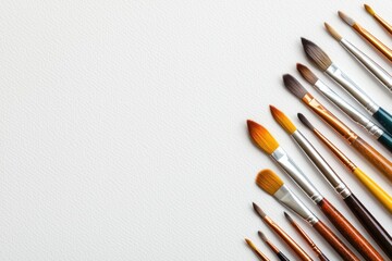 Fototapeta premium Artistic paintbrushes elegantly arranged on textured paper a visual symphony of creative tools