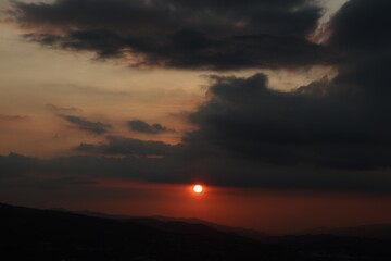 Sunrise over mountains with cloud cover
