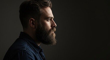 Fototapeta premium Profile Portrait of a Bearded Man in Moody Lighting, Capturing the Intensity of Thought and Contemplation