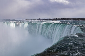 Fog and steam rise from the bottom of Niagara Falls.