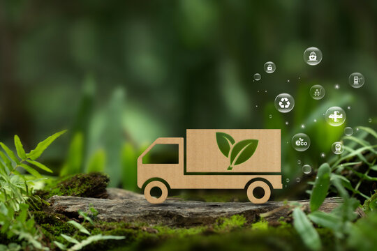 Green logistics and Sustainable transport. Sustainable global transport. Cardboard truck with transport icons on the green. environmentally friendly transportation of goods. zero carbon emission - Powered by Adobe