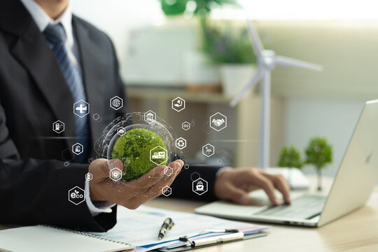 Green logistics and Sustainable transport. Sustainable global transport. businessman holding a green world with transport icons. environmentally friendly transportation of goods. zero carbon emission