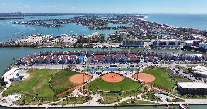 Madeira Beach, FL, USA - 02-23-2025:  Winter aerial video of the vacation beach community and softball park, Madeira Beach, on the Gulf of Mexico.