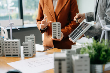 Modern office meeting of architects, designers, and developers creating innovative, sustainable housing projects © Nuttapong punna