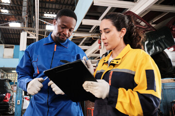 Latin female inspector engineer discussing Black male mechanic, coworker about maintenance service...