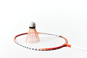 Badminton racket and shuttlecock on white background, shuttlecock hitting racket