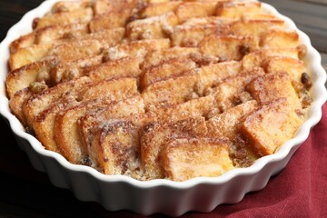 Delicious bread pudding with raisins and cinnamon on table, closeup