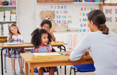 Teacher, education and students in classroom, help and learning with knowledge. Educator, woman and...