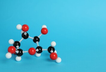 Molecule of glucose on light blue background, space for text. Chemical model