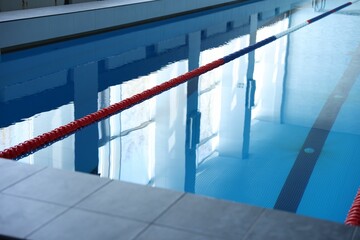 Swimming pool with clean water and lane dividers indoors