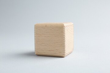 One blank wooden cube on light grey background, closeup