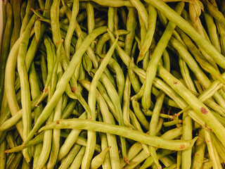 Heap of green pods of raw, not cooked, asparagus beans top view.