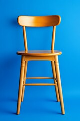 Wooden chair against blue backdrop