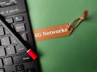Black keyboard and brown card with the word 6g networks on a green background