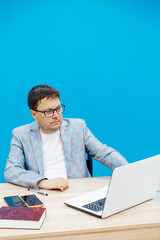 Happy business project manager working from home, using laptop, typing, making video call, looking at screen.