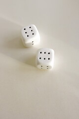 Two white dices isolated on light beige background. Poster, card