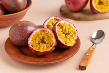 Whole and halved passion fruit slices or maracuya with edible center of juicy pulpy yellow seeds...