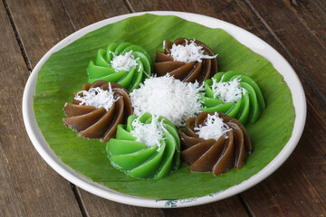 Traditional Malaysian Kuih Kaswi Pandan and Palm Sugar with Grated Coconut Topping