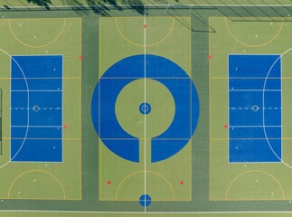 High-angle view of multiple sports courts. Blue playing areas with green field dividers. Perfect...