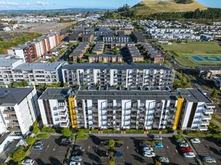Aerial view of modern apartment complex with parking lots. Stylish architecture, urban living....