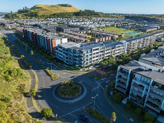 Aerial view of modern apartment complex, roundabout, and residential neighborhood. Urban development in a city setting. ST JOHNS, AUCKLAND, NZ