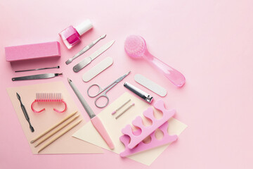 Set of pedicure tools on pink background, flat lay