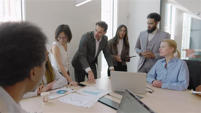 Skilled team analyzes financial data and sales reports to drive success and enhance performance through teamwork, innovation, and open communication in a contemporary office environment