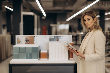 Professional Designer Reviewing Material Samples in a Modern Showroom Setting