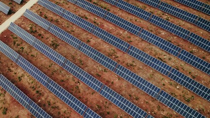A lot of solar panels on a deserted land, a bird's-eye view from a drone