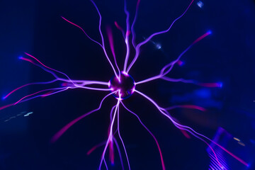 Close-up of a Plasma Ball Showing Intricate Purple and Red Electrical Discharges and Energy Arcs.