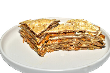 Liver cake, made from minced pork liver and vegetables, lies on a plate.