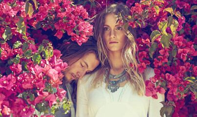 Flowers, nature and couple by bush in garden for spring with casual, stylish and hipster fashion....