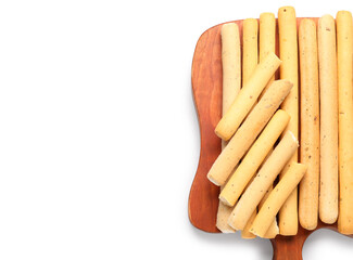 Wooden board with tasty Italian Grissini on white background, closeup