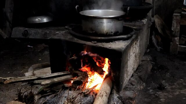 Pot boiling on a traditional rustic wood fire stove