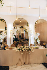Elegant Wedding Dinner Table Decorated With White Flowers and Delicate Tableware