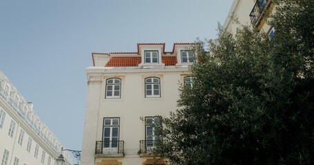 Facade of a white classical building with orange roof tiles, video on a summer day, European architecture