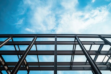 The steel frame structure of the building is visible against the blue sky, showcasing industrial architecture and construction technology with steel beams for an exterior shot.