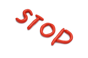 Red word STOP made of play dough on white background