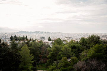 Fototapeta premium Panoramic view of Athens cityscape with greenery and historic ruins